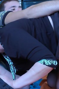 a sexy woman in stockings sitting on her bed while having a big cock